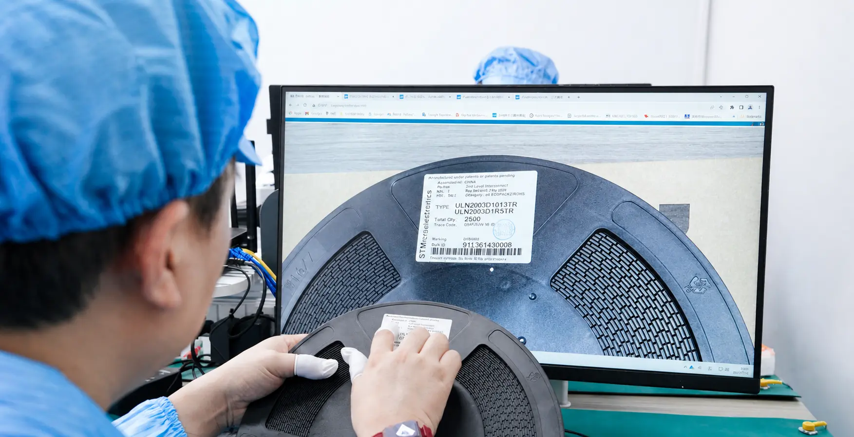 Quality-control technician verifying an electronic component reel against traceability records